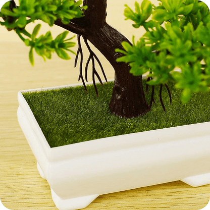 Small artificial bonsai tree in a decorative pot for home styling